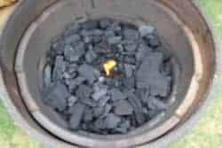 Place a firestarter in the center of the charcoal