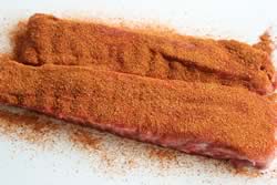 Top side of ribs covered in rub