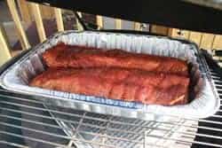 Place pan of ribs on smoker grate