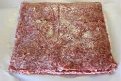 Add top layer of sausage