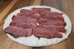 Layer on the strips of sliced smoked corned beef