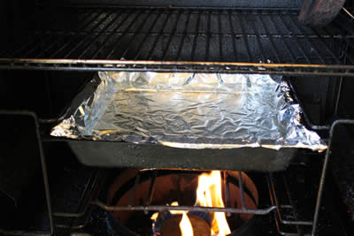 Filled water pan goes into the smoker