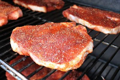 Rubbed pork chops placed directly on smoker grate