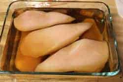 Chicken breasts covered in brine