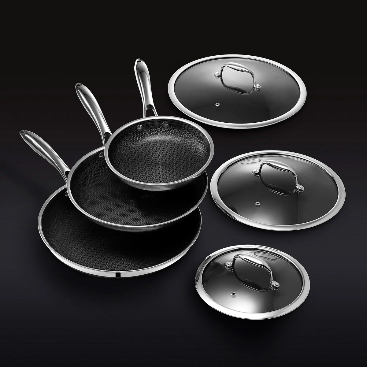 Complete HexClad 6-piece frying pan set showing three frying pans and three lids