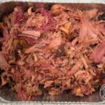 Smoked pulled ham in a foil pan