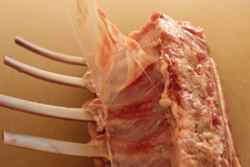 Rack of lamb with membrane being removed