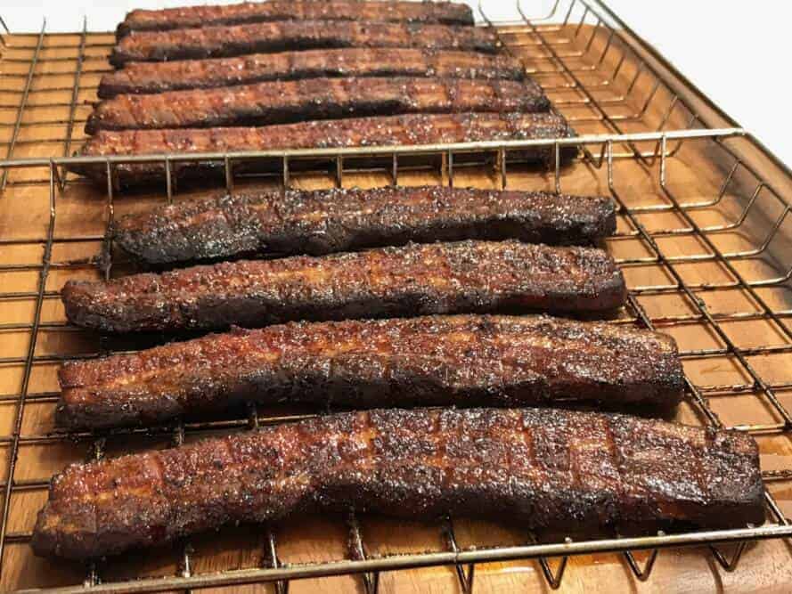 Using wire coat hanger to make easy way to cook fish over barbecue